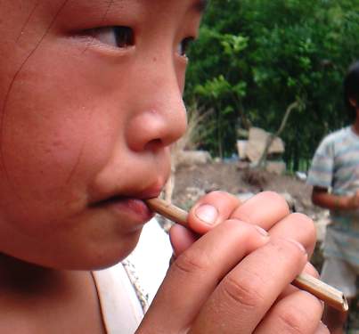 Child blowing dongdongkui flute